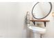 Well-lit powder room features a pedestal sink, modern mirror, and stylish decor for guests' convenience at 301 White Oak Ridge Dr, Garner, NC 27529