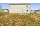 Exterior backyard view showcasing a patio and grassy area, plus the home's siding at 32 Bellini Dr, Angier, NC 27501