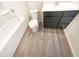 Clean bathroom featuring modern fixtures and stylish vanity with a tub and shower combo at 32 Bellini Dr, Angier, NC 27501