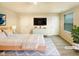 Modern bedroom with stylish furniture, TV, and bright neutral decor and natural light at 32 Bellini Dr, Angier, NC 27501