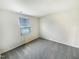 Basic empty bedroom with neutral walls and carpet and a window with blinds at 32 Bellini Dr, Angier, NC 27501