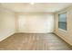 Spacious bedroom with neutral colored walls and carpet and two doors and a window at 32 Bellini Dr, Angier, NC 27501