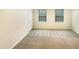 Bright bedroom with neutral carpet, two windows, and a closet, offering comfort and functionality at 32 Bellini Dr, Angier, NC 27501