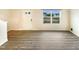Spacious living area with wood-look flooring, a large window, and a neutral color palette, creating a versatile space at 32 Bellini Dr, Angier, NC 27501
