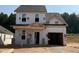 Two-story home with an attached garage in the beginning stages of construction with a large front yard at 322 Bluejay St, Clayton, NC 27520