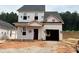 New construction two-story home featuring an attached garage and a partially covered front porch at 322 Bluejay St, Clayton, NC 27520