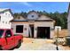 New construction home featuring modern design with a two-car garage in a developing neighborhood at 330 Bluejay St, Clayton, NC 27520