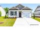 Charming single-Gathering home with a white garage, black door, and a well-maintained lawn at 330 Bluejay St, Clayton, NC 27520