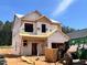 New construction home with protective wrap, showcasing modern design elements and a promising residential space at 338 Bluejay St, Clayton, NC 27520
