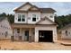 Two-story home featuring an unfinished exterior, a front entrance, and an attached garage at 338 Bluejay St, Clayton, NC 27520