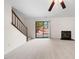 Bright living room with neutral carpet, fireplace, and sliding glass door to the backyard at 359 Kilarney Dr, Durham, NC 27703