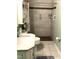 Bathroom featuring a walk-in shower with grab bars, tiled walls, and a white marble top vanity at 4159 Princeton Kenly Road, Kenly, NC 27542
