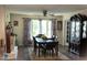 Inviting dining room featuring hardwood floors, ceiling fan, and large windows with backyard views at 4159 Princeton Kenly Road, Kenly, NC 27542