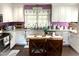 Bright and airy kitchen with sleek white cabinetry, granite countertops, and stainless steel appliances at 4159 Princeton Kenly Road, Kenly, NC 27542