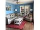 Inviting living room featuring a comfortable L-shaped couch, ceiling fan, and french doors to bring in plenty of light at 4159 Princeton Kenly Road, Kenly, NC 27542