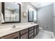Bathroom features a dual sink vanity, a walk-in shower, and elegant fixtures at 4290 Sustain Cir, Franklinton, NC 27525
