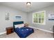 Bright bedroom with fun space-themed decor, features a large window offering abundant natural light at 4290 Sustain Cir, Franklinton, NC 27525