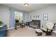 Comfortable Bedroom with ample space and charming decor, features a crib, desk, and glider at 4290 Sustain Cir, Franklinton, NC 27525