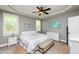 Bedroom featuring a neutral color scheme, tray ceilings, and natural light from two windows at 4290 Sustain Cir, Franklinton, NC 27525