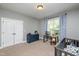 Comfortable Bedroom with ample space and charming decor, features a crib, desk, and glider at 4290 Sustain Cir, Franklinton, NC 27525
