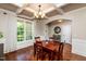 Dining room features coffered ceilings, hardwood floors, and large windows providing natural light at 4290 Sustain Cir, Franklinton, NC 27525