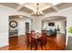 Open-concept dining area boasts coffered ceilings and hardwood floors, flowing into living area at 4290 Sustain Cir, Franklinton, NC 27525