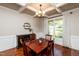 Dining room with elegant coffered ceiling, wood floors, and natural lighting at 4290 Sustain Cir, Franklinton, NC 27525
