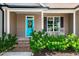 Inviting front porch with rocking chairs and a turquoise front door at 4290 Sustain Cir, Franklinton, NC 27525