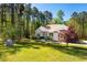 Charming home with a manicured front yard and lush landscaping surrounded by mature trees at 4290 Sustain Cir, Franklinton, NC 27525