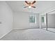 Bright, airy bedroom with neutral carpet, ceiling fan and natural light from the windows at 501 Gooseneck Dr # B6, Cary, NC 27513