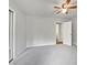 Carpeted bedroom with closet, ceiling fan, and white door is ready for your personal touch at 501 Gooseneck Dr # B6, Cary, NC 27513