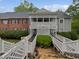 Charming condo exterior featuring a covered porch, brick accents, and landscaped surroundings at 501 Gooseneck Dr # B6, Cary, NC 27513