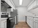 Well-lit kitchen features stainless steel appliances, white cabinetry, and a light countertop at 501 Gooseneck Dr # B6, Cary, NC 27513