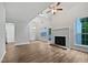 Open living room features a fireplace, high ceilings, large windows, and wood flooring at 501 Gooseneck Dr # B6, Cary, NC 27513