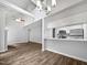 Bright, open-concept living room and kitchen space with wood floors and stainless steel appliances at 501 Gooseneck Dr # B6, Cary, NC 27513