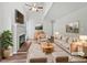 Bright, staged living room featuring a fireplace, ceiling fan and a neutral color palette at 501 Gooseneck Dr # B6, Cary, NC 27513