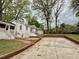 Backyard view of the house featuring a brick-lined patio and well-maintained lawn at 508 & 510 Gordon St, Roxboro, NC 27573