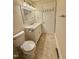 Bathroom with neutral tiling, a large mirror, and a white toilet and vanity at 508 & 510 Gordon St, Roxboro, NC 27573
