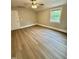 This bedroom offers wood-look flooring, a ceiling fan, neutral walls and a window at 508 & 510 Gordon St, Roxboro, NC 27573