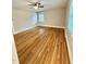 Bright bedroom has hardwood floors, ceiling fan, a large window, and neutral paint at 508 & 510 Gordon St, Roxboro, NC 27573
