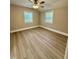 This bedroom features wood-look flooring, a ceiling fan and two windows at 508 & 510 Gordon St, Roxboro, NC 27573