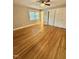 This bedroom features hardwood floors, a ceiling fan, and a closet with sliding doors at 508 & 510 Gordon St, Roxboro, NC 27573