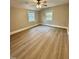 This bedroom features a vaulted ceiling, ceiling fan, neutral paint and wood-look flooring at 508 & 510 Gordon St, Roxboro, NC 27573