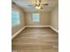 This bedroom features wood-look flooring, a ceiling fan and two windows at 508 & 510 Gordon St, Roxboro, NC 27573