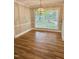 A dining area with hardwood floors and a large window offering an outdoor view at 508 & 510 Gordon St, Roxboro, NC 27573