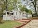 Exterior view showcasing a screened porch and brick accents leading to the backyard at 508 & 510 Gordon St, Roxboro, NC 27573