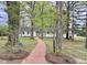 Charming home with a brick walkway leading through a tree-filled front yard at 508 & 510 Gordon St, Roxboro, NC 27573
