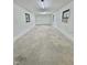 Open garage area featuring concrete floor, white walls, and natural light from windows at 508 & 510 Gordon St, Roxboro, NC 27573