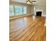 Spacious living room with hardwood floors, fireplace, large windows, and ample natural light at 508 & 510 Gordon St, Roxboro, NC 27573