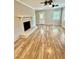 Inviting living room with brick fireplace, lots of natural light, and updated flooring at 508 & 510 Gordon St, Roxboro, NC 27573